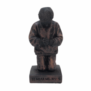 Sculpture Called to pray young boy