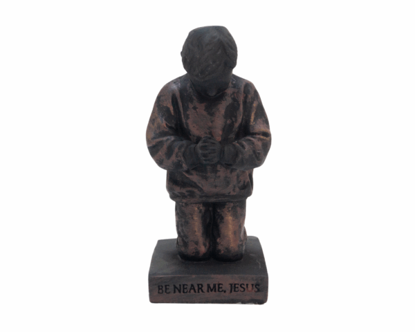 Sculpture Called to pray young boy